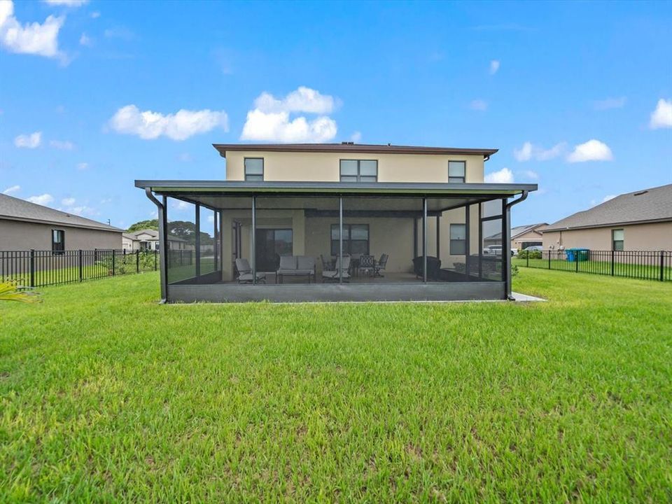 Rear of the property from the front, looking at covered back patio