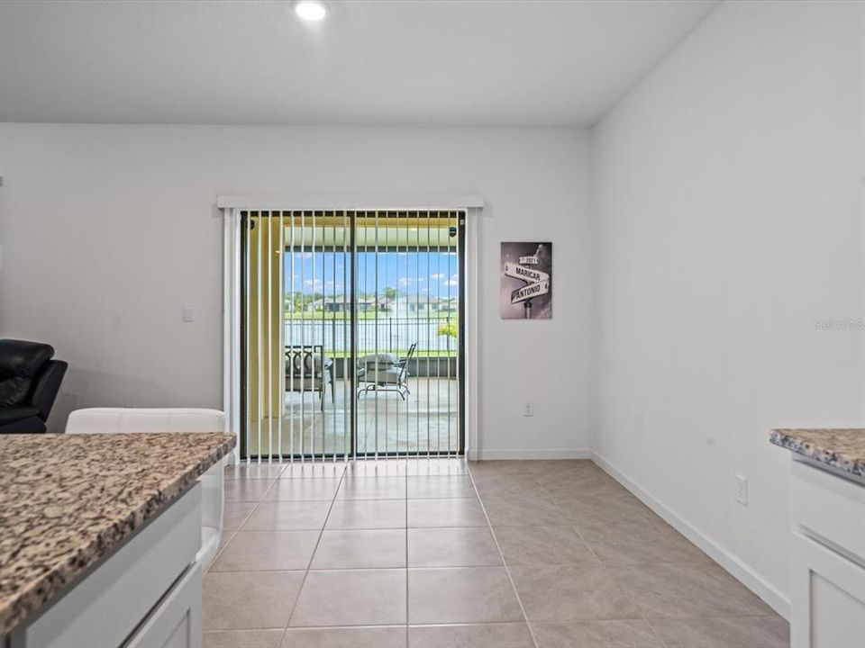 From the kitchen, looking at the sliding door that takes you to the covered back patio.