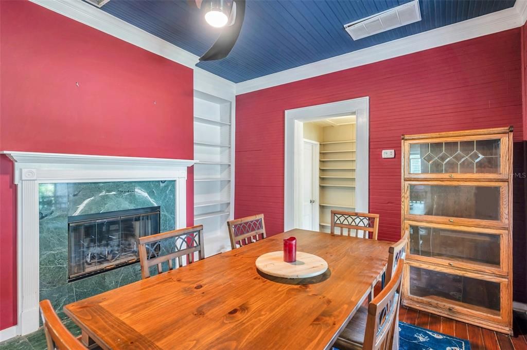 Dining Room with Built-In Shelving and Wood-Burning Fireplace