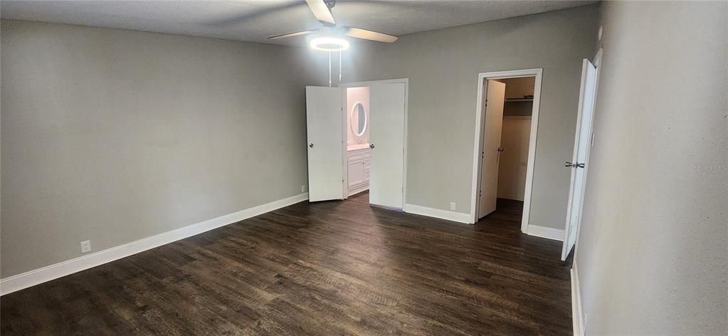 Master bedroom with walk in closet and en-suite bathroom