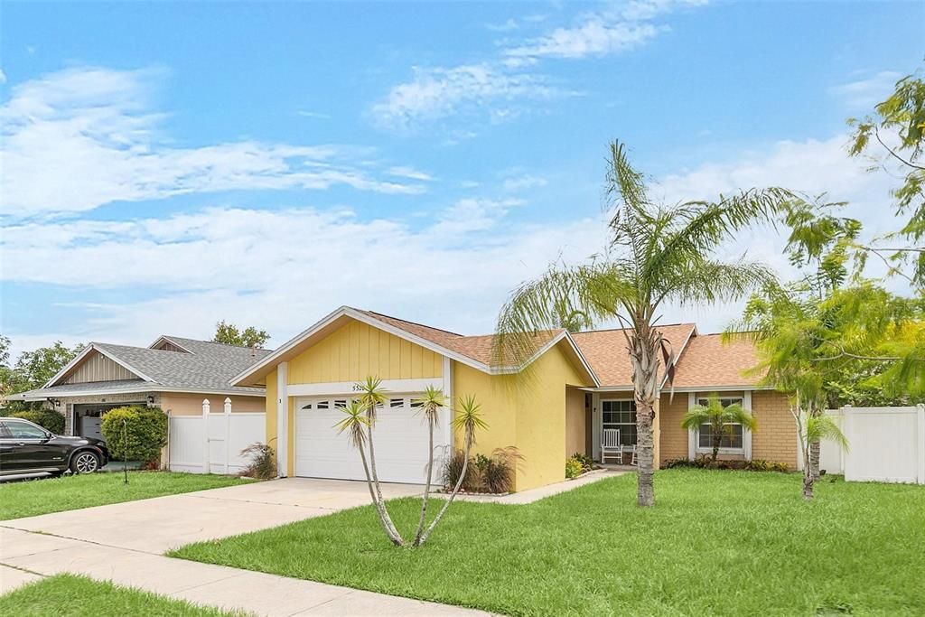 Charming and bright, this lovely yellow home offers a welcoming front porch, lush landscaping, and a  prime location in a friendly neighborhood.