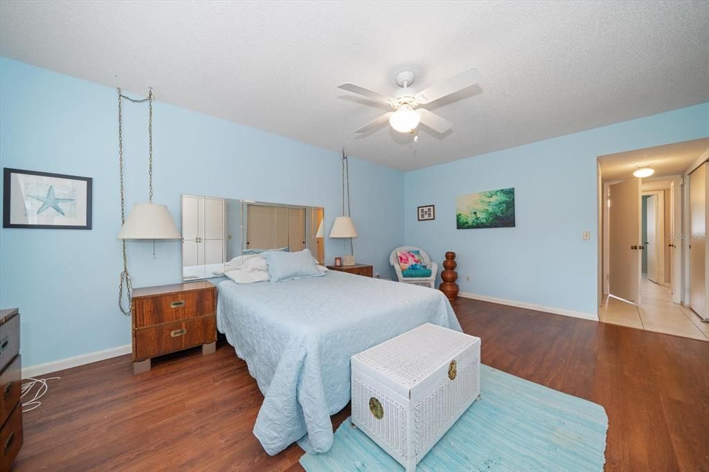 Primary bedroom with luxury vinyl flooring