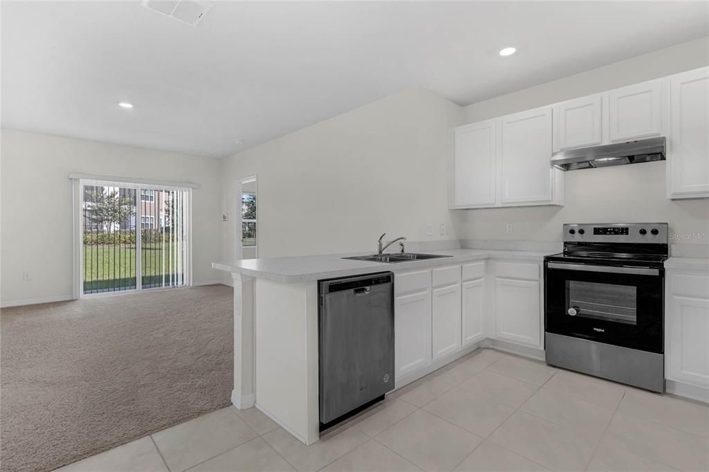 Kitchen with view of peninsula looking over to the living room