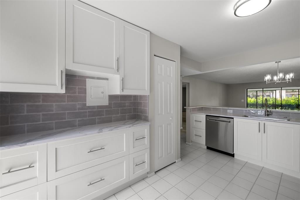 Fully renovated kitchen with brand new dishwasher, refrigerator, fixtures, cabinets, and tile backsplash