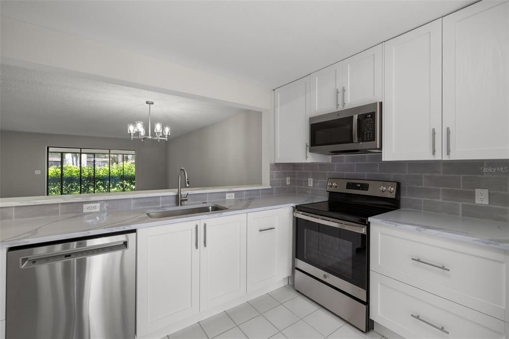 New quartz countertops, tile backsplash and cabinetry