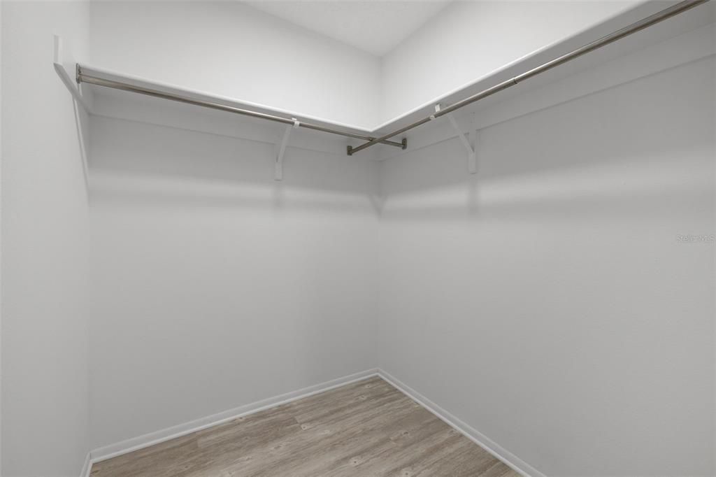 Primary bedroom walk in closet