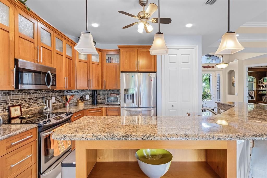 The kitchen has granite counters and stainless steel appliances