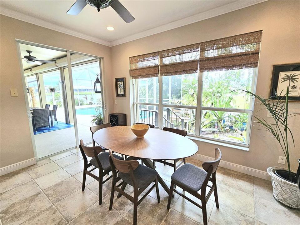 Dining room with lake views and sliders to pool