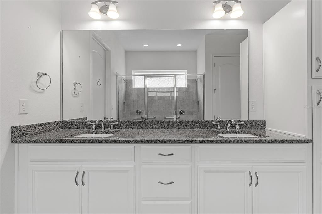 Adult size vanity with dual sinks and granite countertop