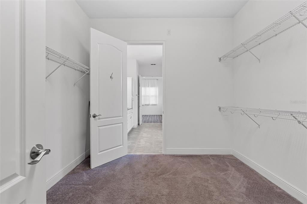 Walk-in closet flows into laundry room