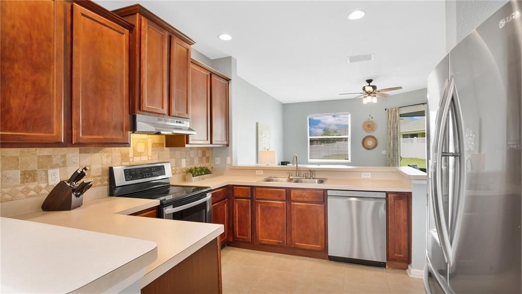 Kitchen with Breakfast Bar and Stainless Steel Appliances