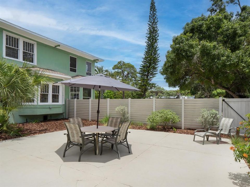 Huge patio area surrounded by a new vinyl privacy fence.