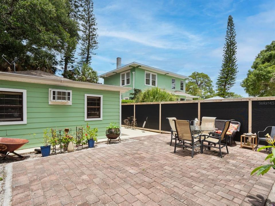 Fence offers privacy for private brick patio area for carriage house apartments.