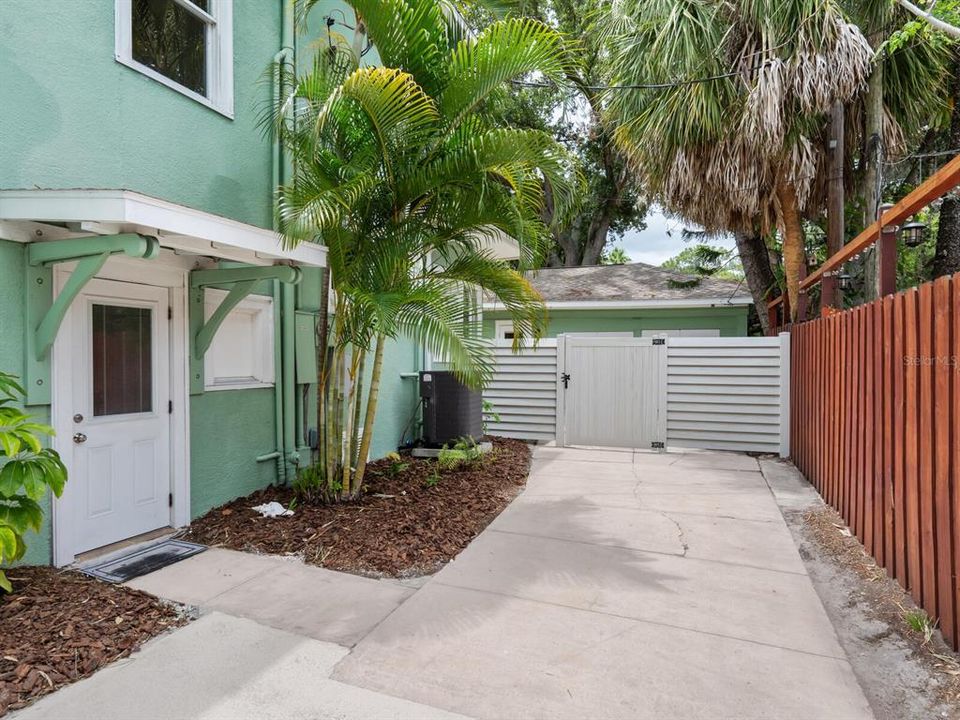 Extended driveway with side access door.