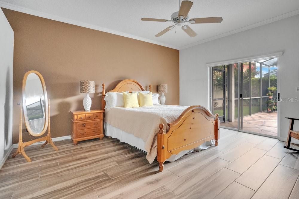 Primary Bedroom with glass sliders onto pool deck