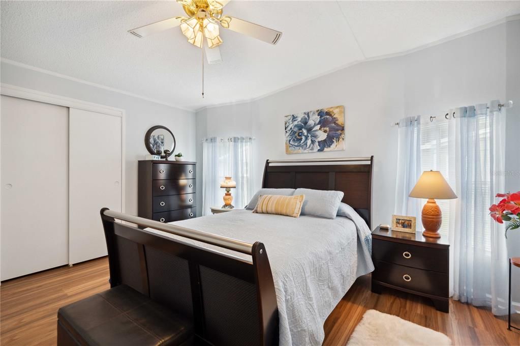 Main bedroom has new flooring, ceiling fan, and fresh paint.