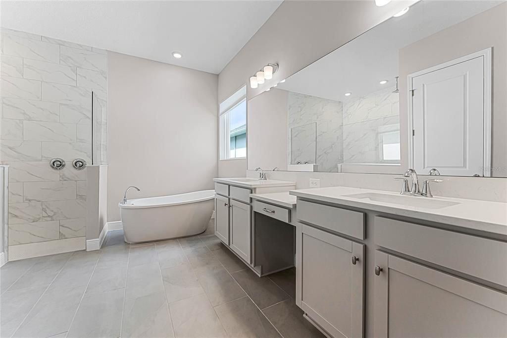 Primary Bathroom with Dual Vanity sinks, garden tub and walk in shower.