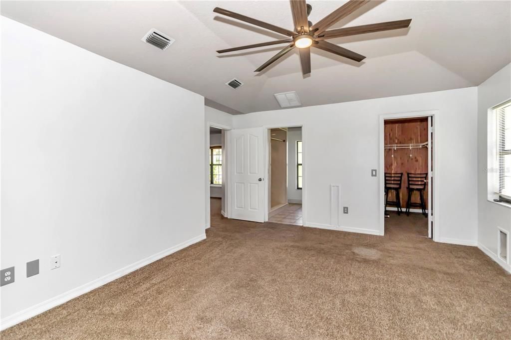 Primary Bedroom with walk-in closet with cedar siding.