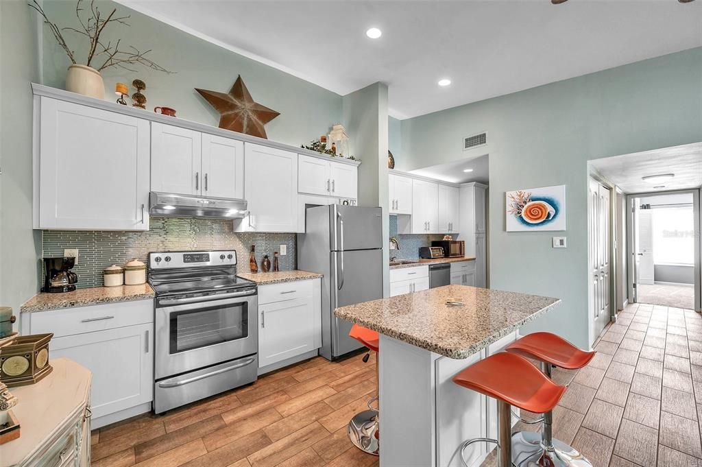 Island in the kitchen creates a great eating area and great counter space for cooking, baking and entertaining