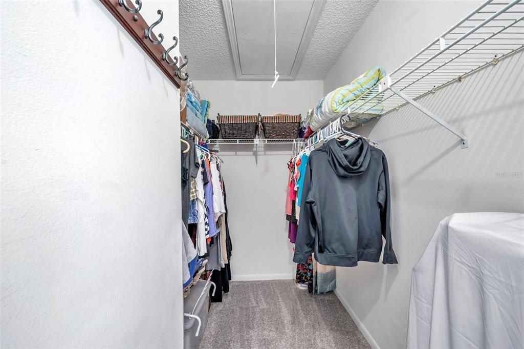 Walk in closet in Primary Suite with folding stairs to the attic