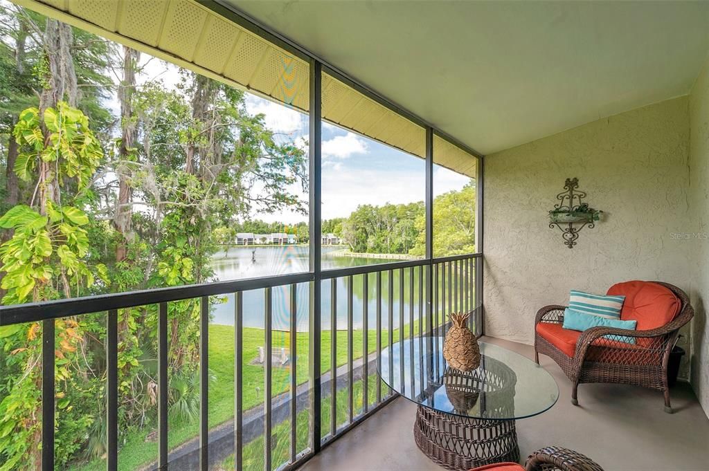 Screened balcony overlooks the pond where  you can enjoy tranquility and often see wildlife