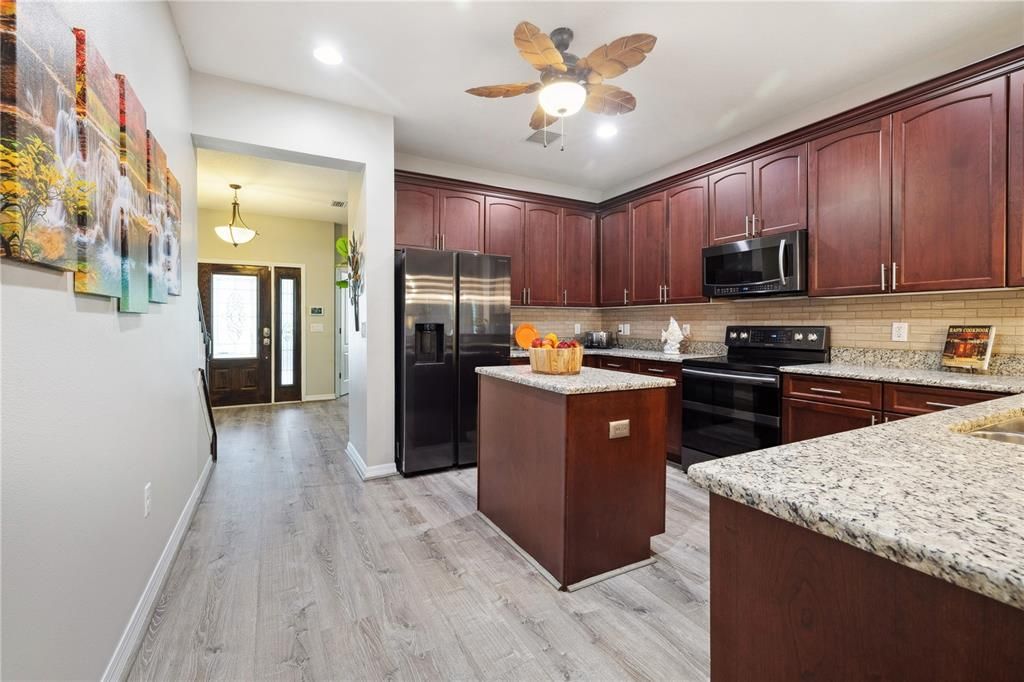 Ample kitchen, featuring a large walk-in pantry that extends under staircase