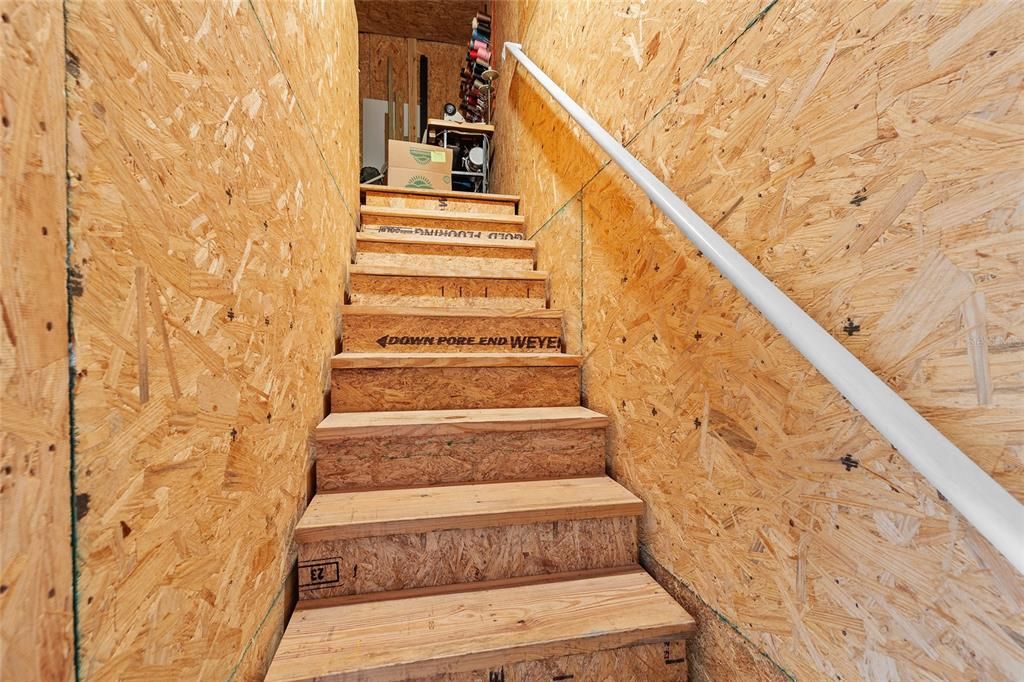 Stairs in garage lead to a room.