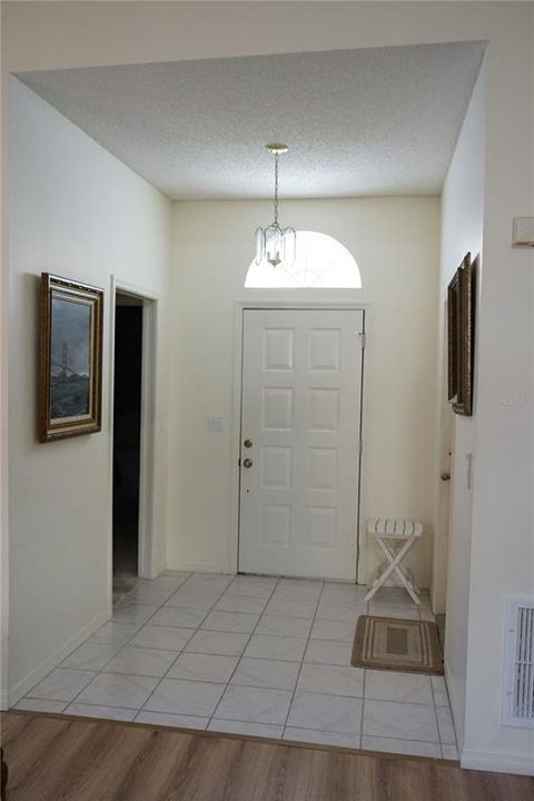 foyer has tile and guest area is to the left