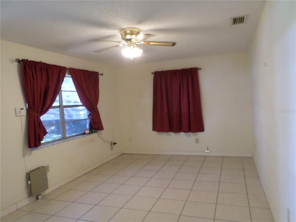 LIVING ROOM OPENS TO KITCHEN TILE FLOORING THROUGHOUT