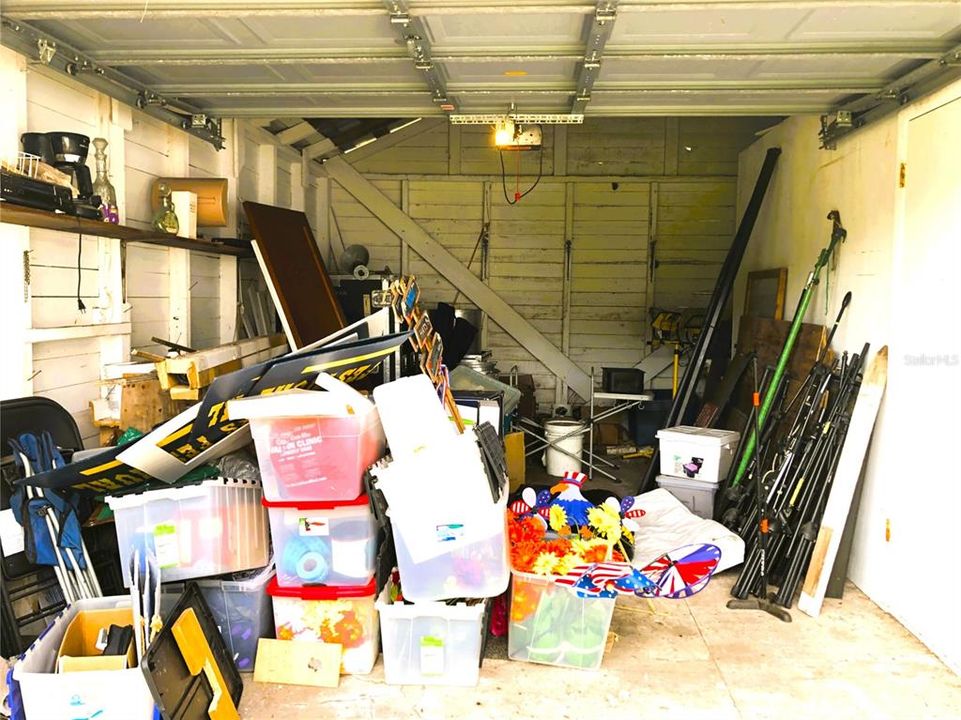 BACK SIDE OF 3RD GARAGE UNDER TREES & HOUSES THE  GRANDFATHERED IN WELL FOR GARDENING