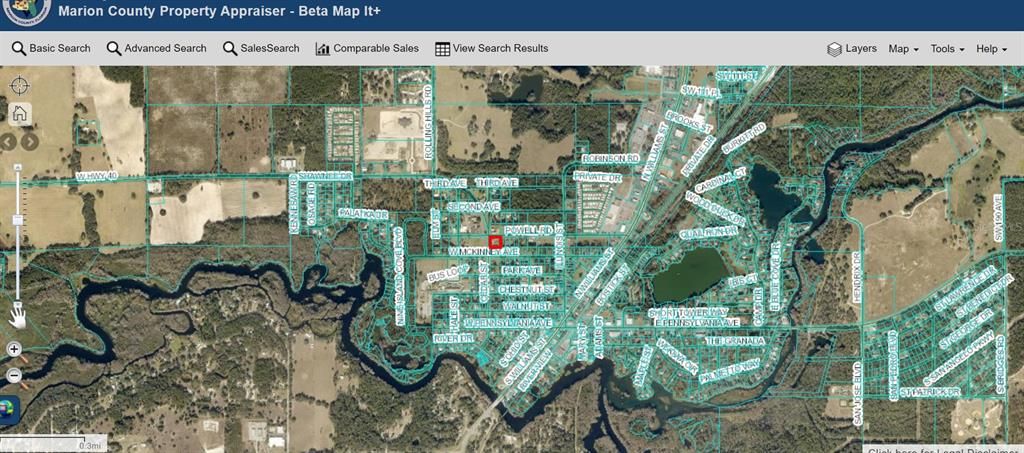 RED DOT ON COUNTY AERIAL SHOWS PROXIMITY TO GULF OF MEXICO