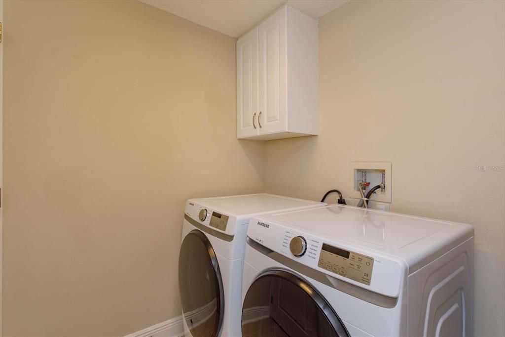 Downstairs laundry room plus storage closet under the stairs