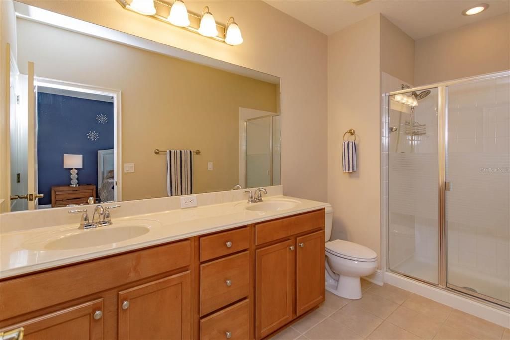 Dual cultured marble sinks plus walk in shower in primary bathroom