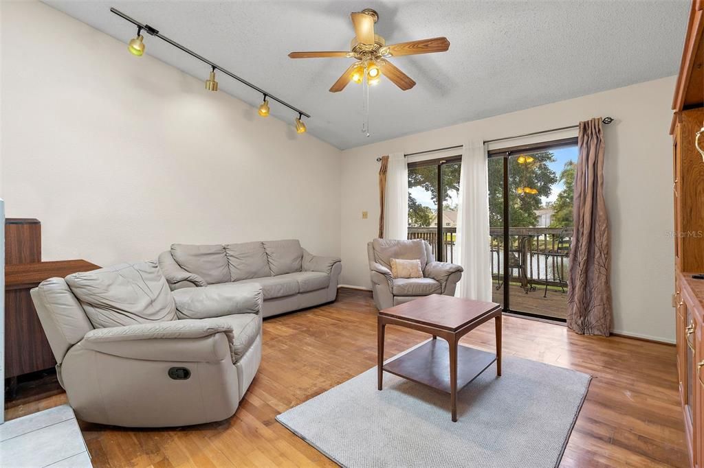 living room with balcony overlooking lake