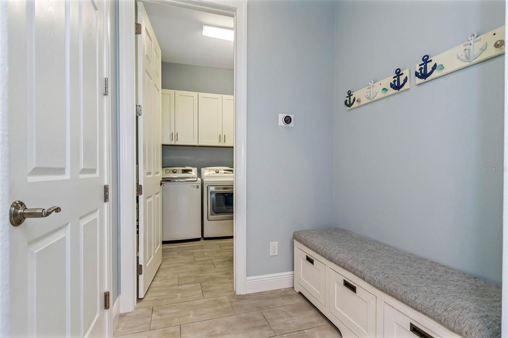 Indoor large laundry room with mudroom off from the garage