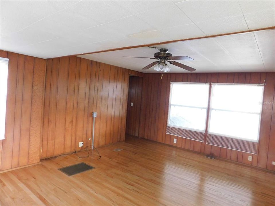 Light filled living area wired for electric fireplace.