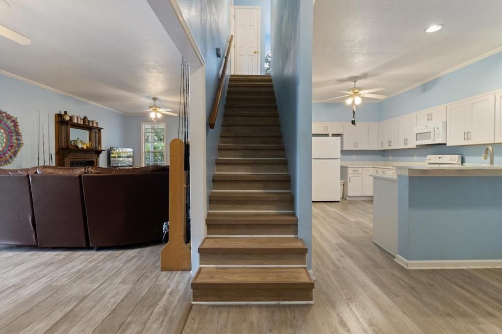 Stairs between living room and kitchen. Second floor guest rooms. Bonus room