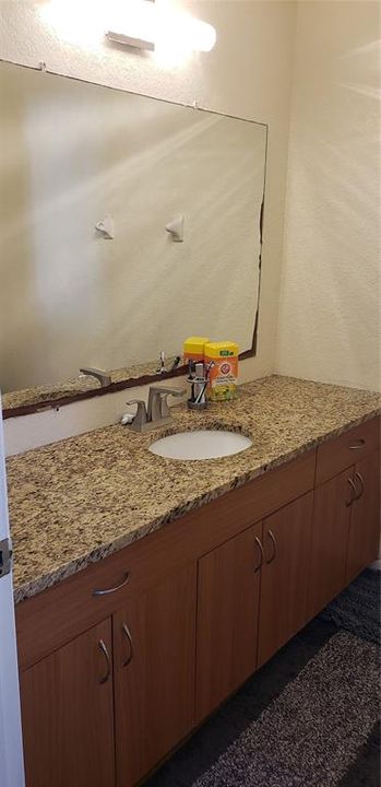 Master bathroom vanity area with granite counter