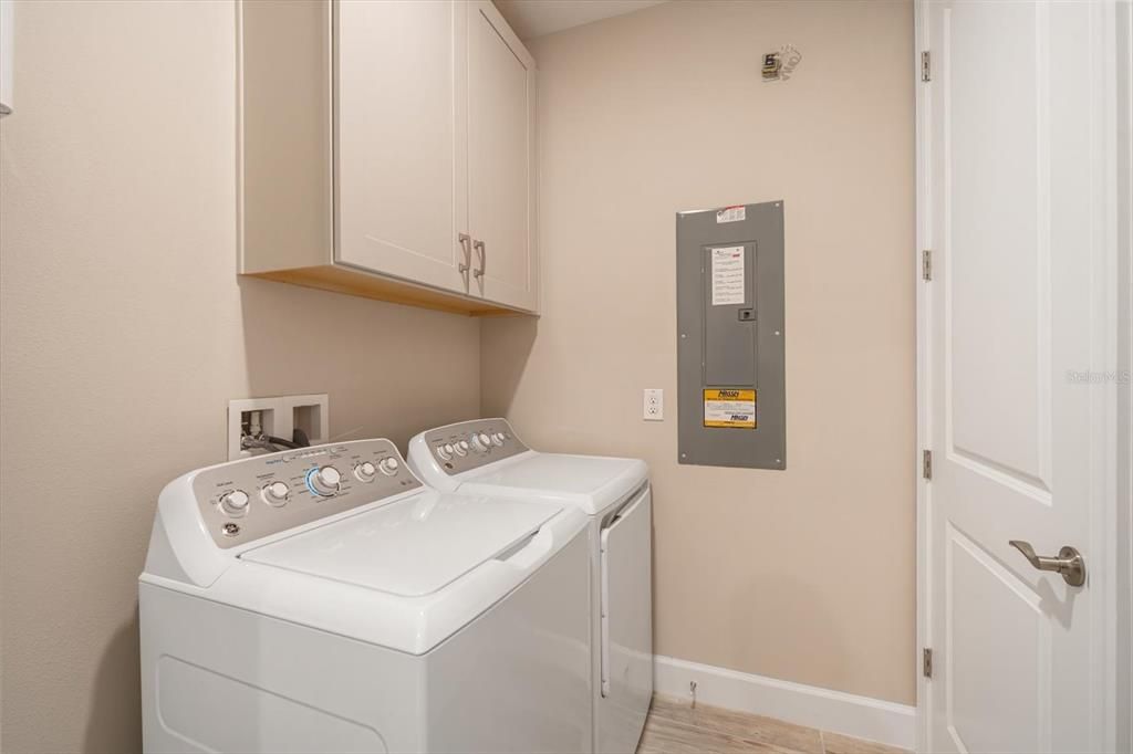 Laundry room with cabinets and tankless HWH