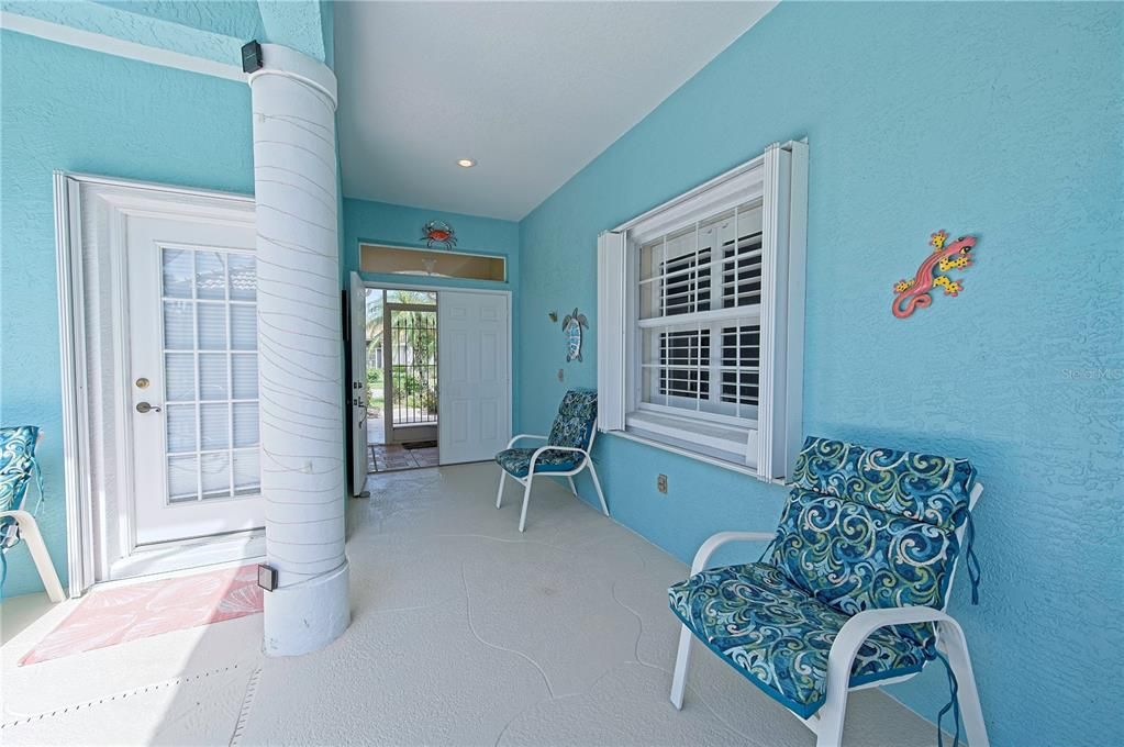 View looking toward the front entry and driveway from inside the pool courtyard area