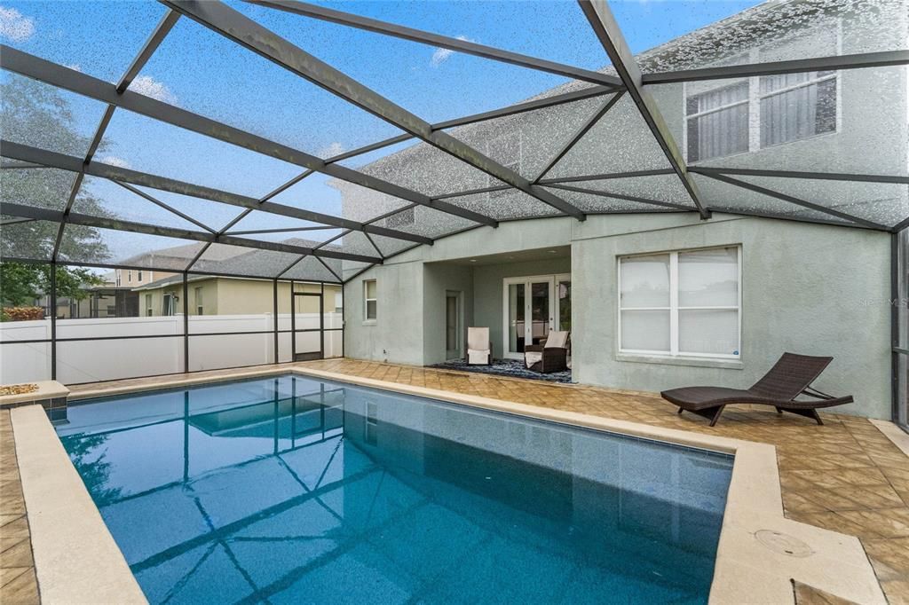 Screened Pool enclosure. Lovely lagoon pool. Covered Patio.