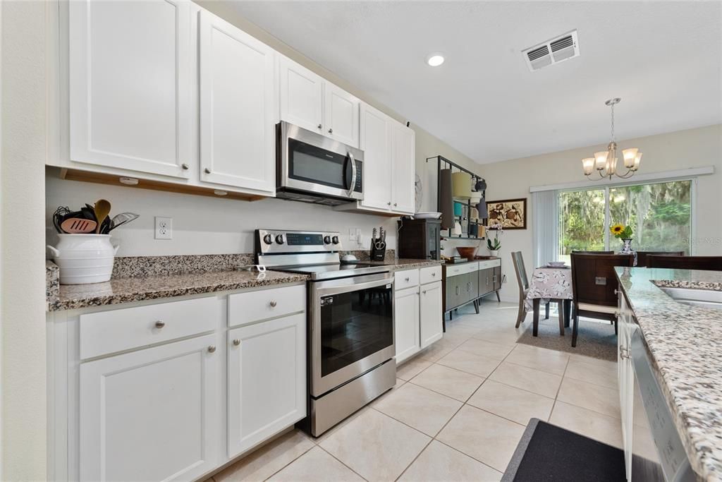 Kitchen with stainless steel microwave, stove & cooktop