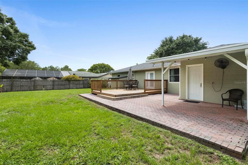 Paver patio with wooden deck makes for great entertaining space.