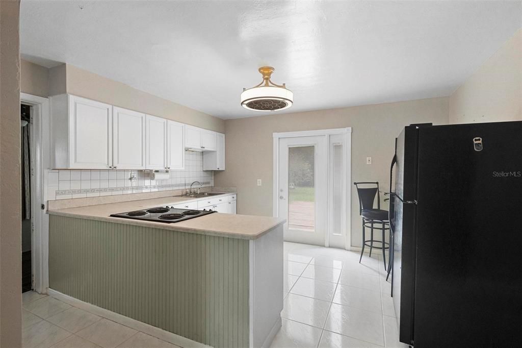 Kitchen with door exiting to the backyard.