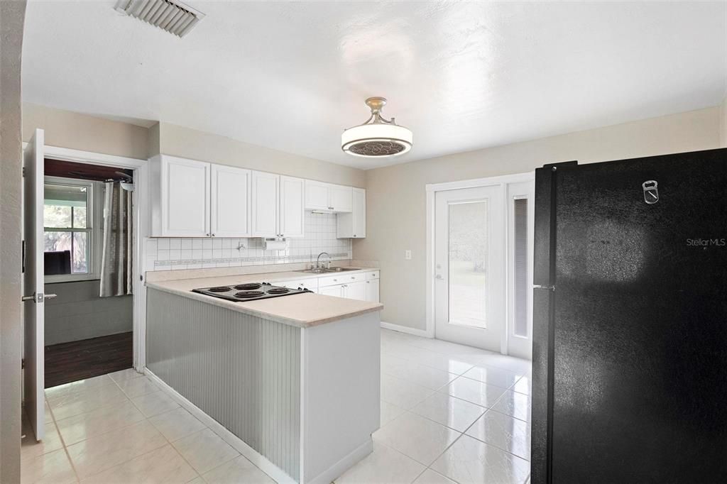 Hard wood cabinets and updated fan/lighting fixture keep this space nice and cool.