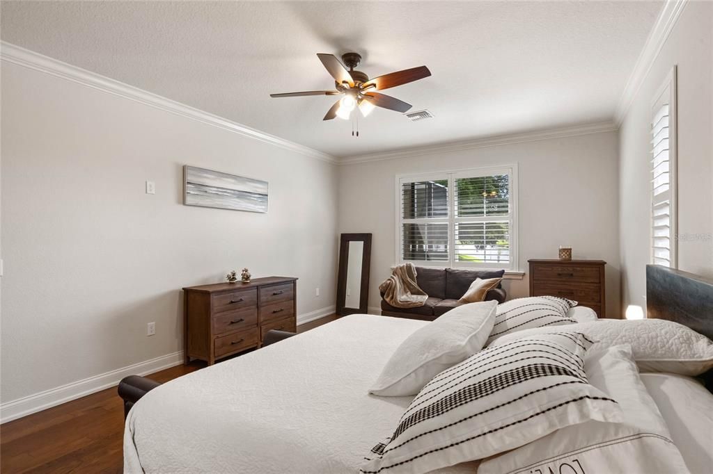 Primary Suite with Wood Flooring, Ceiling Fan & Crown Molding