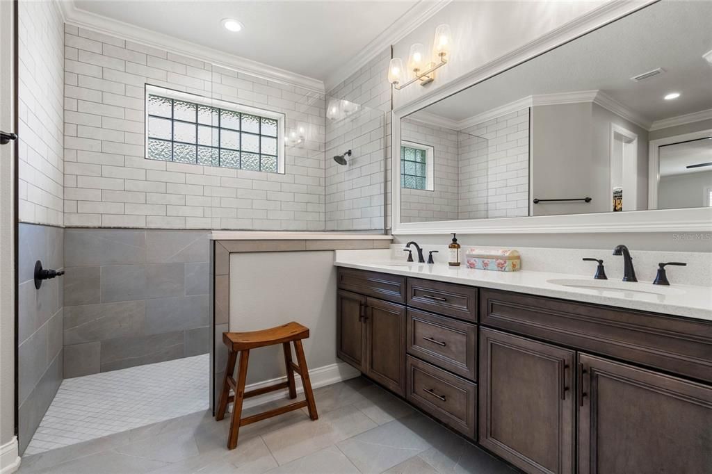 Primary Bathroom offers a Large Vanity with Dual Sinks, Kohler Faucets & Water Closet with Comfort Height Toilet