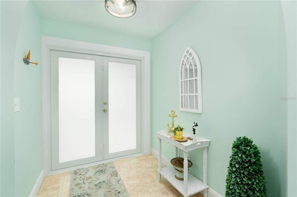 Entryway featuring french doors and light tile floors