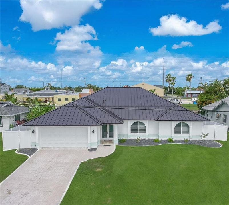 View of front of home with a garage and a front yard