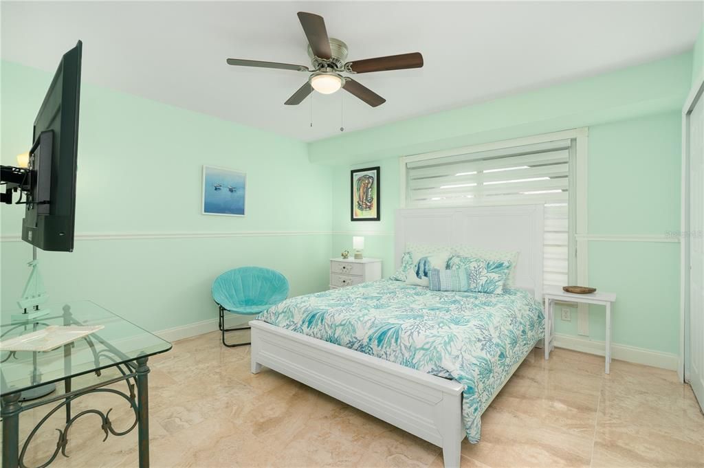 Bedroom featuring ceiling fan and light tile floors